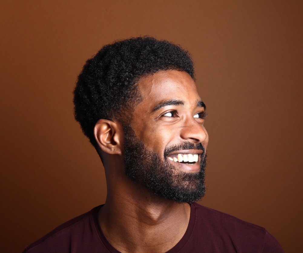 Beautiful black man in front of a brown background